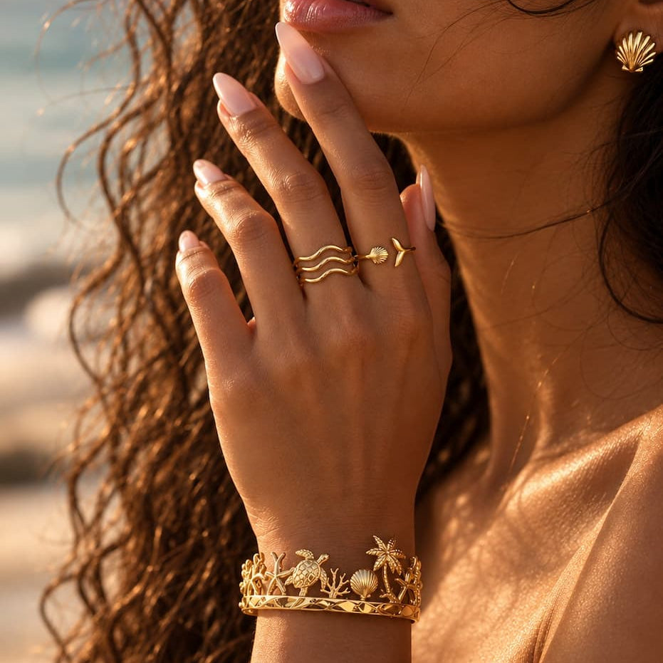 Buccoo Reef gold cuff worn with rings